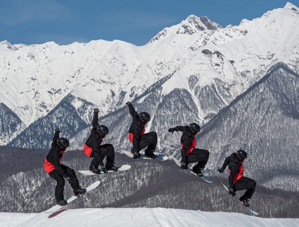 Burst photo images of a snowboarding doing a trick