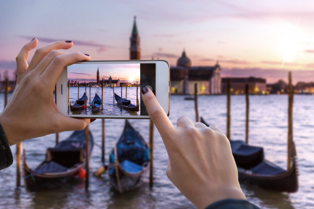 Woman taking photo of a dock on her phone