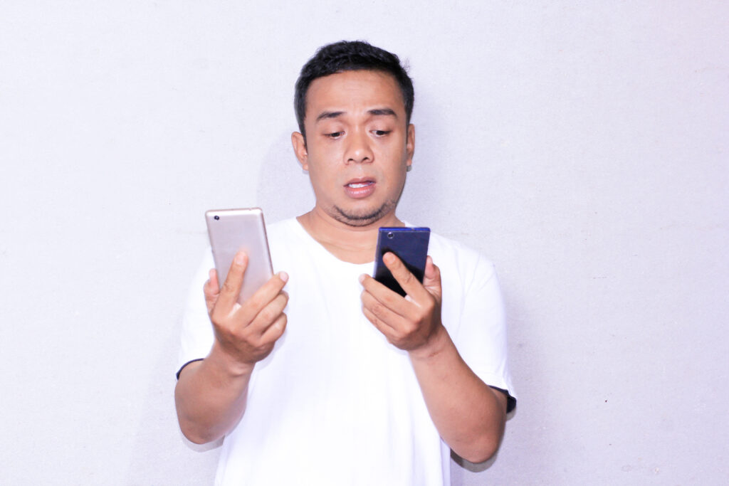 How To Choose The Right Phone (Without Losing Your Mind) 🤯📱 Man choosing the right phone between two options, looking confused