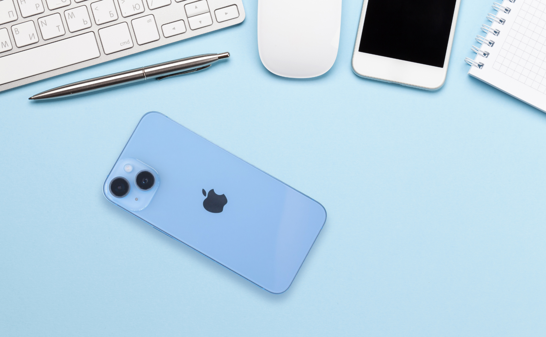 Iphone 14 colours: blue on blue desk