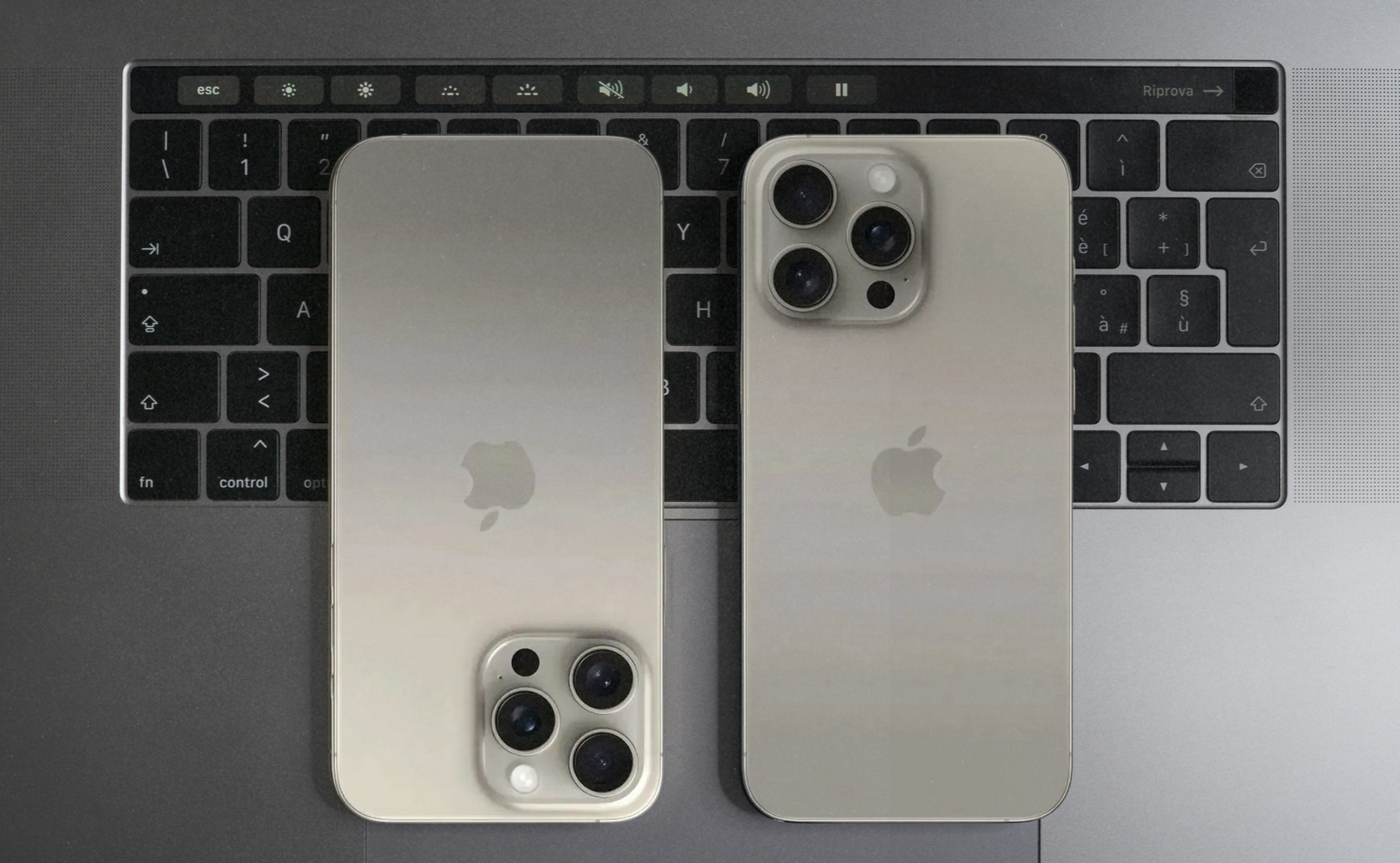 Iphone 15 colours: natural titanium on top of macbook keyboard