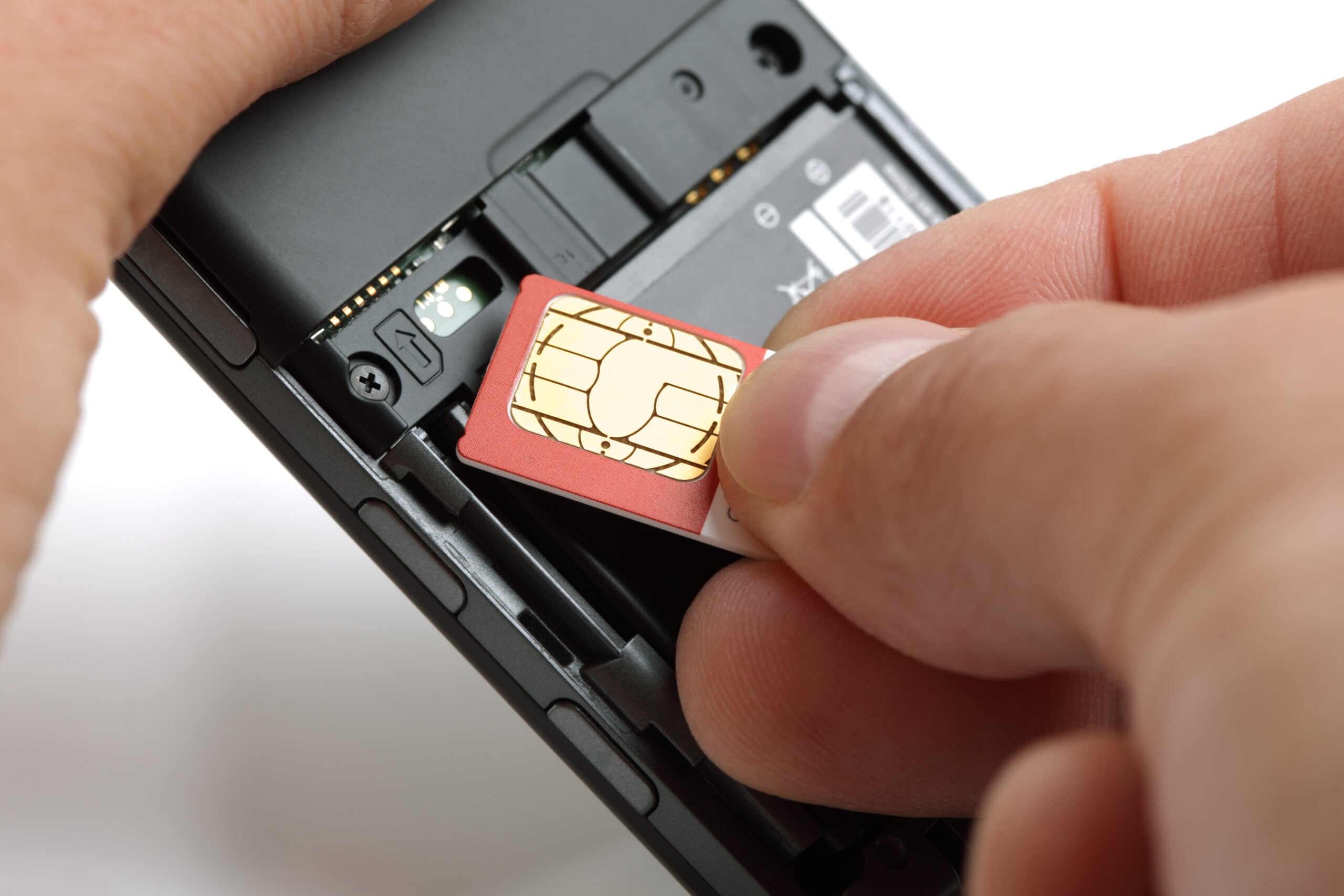 Inserting, a, sim, card, into, the, back, of, an, unlocked phone