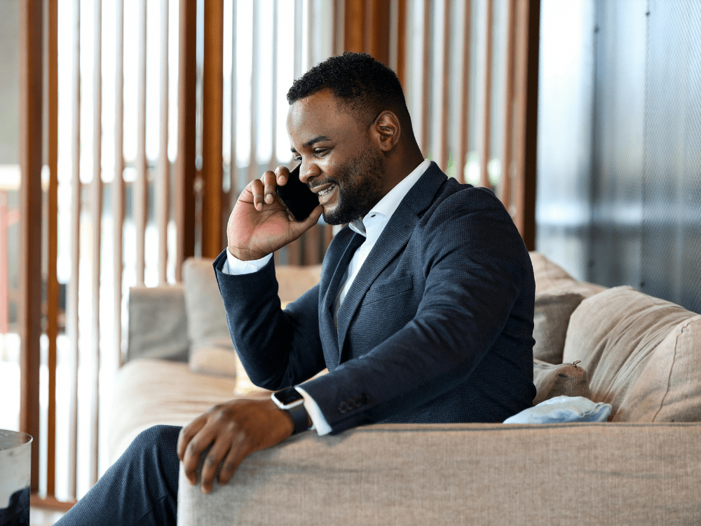 The Big Phone Store Honesty Policy Business man in suit on phone call in modern office space
