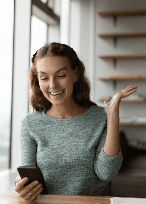 Are Refurbished Phones Worth It? Cost, Reliability &Amp; Performance Explained Happy woman exclaiming with her refurbished phone