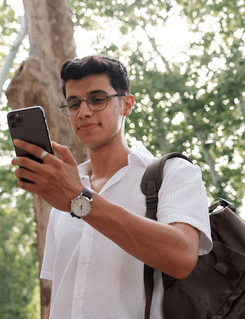 Are Refurbished Phones Worth It? Cost, Reliability &Amp; Performance Explained Man using refurbished phone surrounded by nature