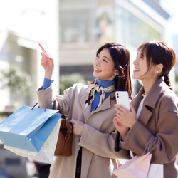 Are Refurbished Phones Worth It? Cost, Reliability &Amp; Performance Explained Two girls with shopping bags browsing