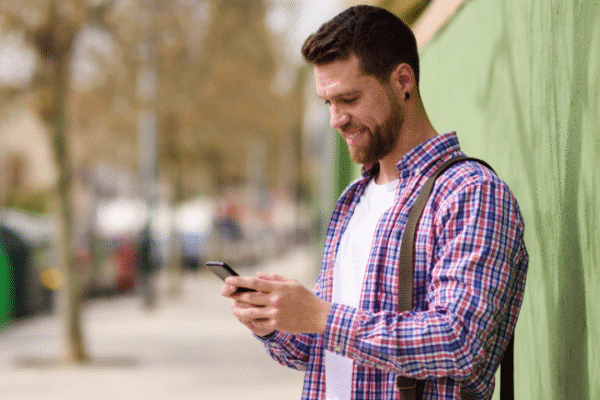 Man happy using fast refurbished phone