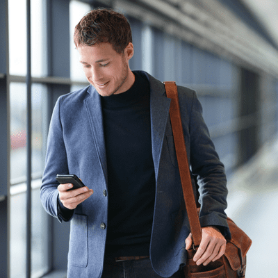 Fraud Prevention &Amp; Device Ownership Policy (For Trade Ins) Man in airport checking phone