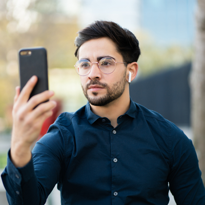 Fraud Prevention &Amp; Device Ownership Policy (For Trade Ins) Man attempting to use face id on phone